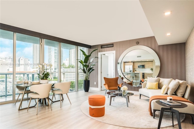 185 SW 7th St Unit 803, Miami, FL 33130 - living room featuring wallpapered walls, floor to ceiling windows, wood finished floors, and a city view