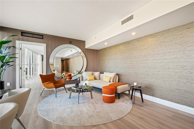 185 SW 7th St Unit 803, Miami, FL 33130 - living room with wallpapered walls, light wood-type flooring, and an accent wall