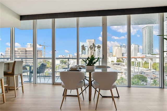 185 SW 7th St Unit 803, Miami, FL 33130 - dining area with floor to ceiling windows, a view of skyline, healthy amount of natural light, and wood finished floors