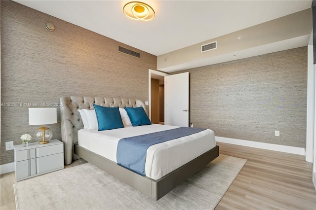 185 SW 7th St Unit 803, Miami, FL 33130 - bedroom with wallpapered walls and wood finished floors