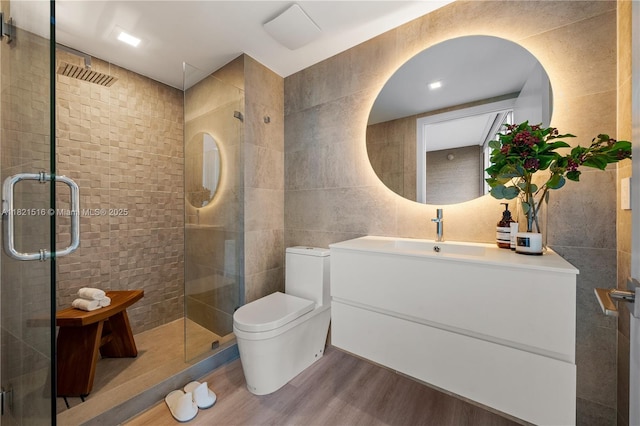 185 SW 7th St Unit 803, Miami, FL 33130 - full bath with tile walls, wood finished floors, a stall shower, and vanity