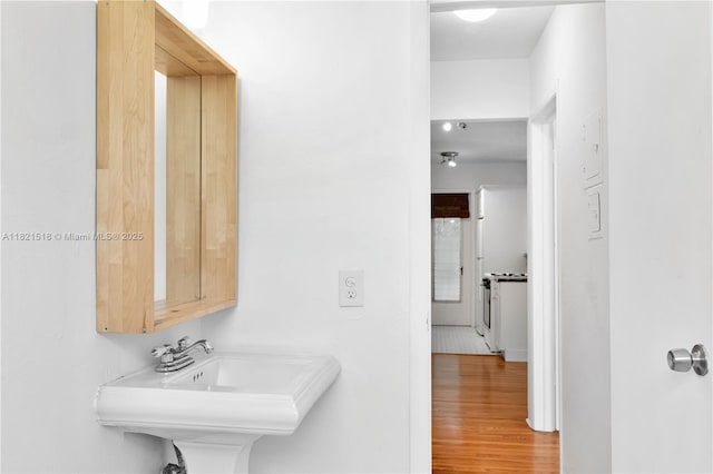 101 Collins Ave Unit 16, Miami Beach, FL 33139 - bathroom with wood finished floors and a sink