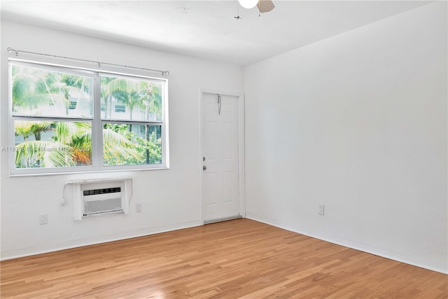 101 Collins Ave Unit 16, Miami Beach, FL 33139 - spare room with a wall mounted air conditioner, light wood-style floors, and a ceiling fan