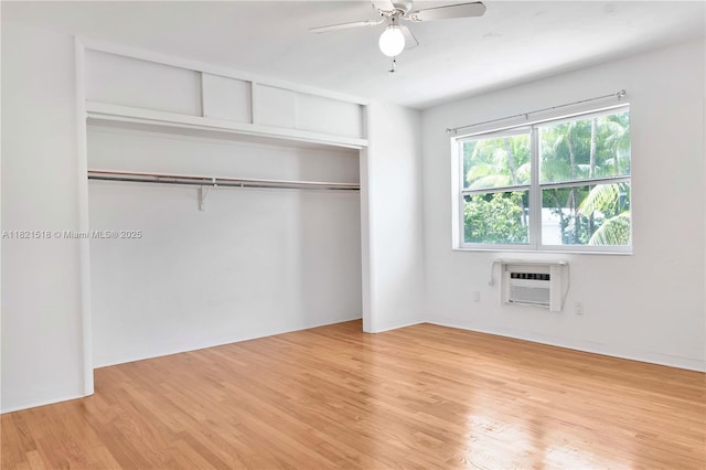 101 Collins Ave Unit 16, Miami Beach, FL 33139 - unfurnished bedroom featuring an AC wall unit, light wood finished floors, a closet, and ceiling fan