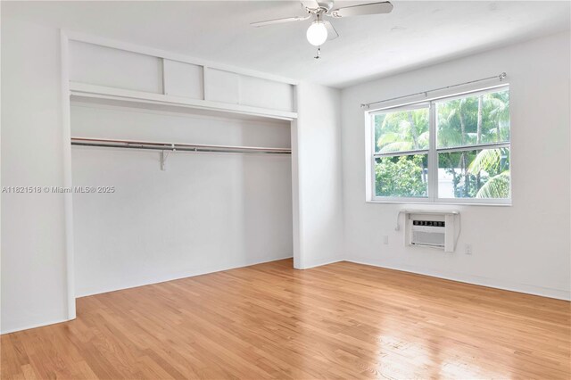 101 Collins Ave Unit 16, Miami Beach, FL 33139 - unfurnished bedroom featuring an AC wall unit, light wood finished floors, a closet, and ceiling fan