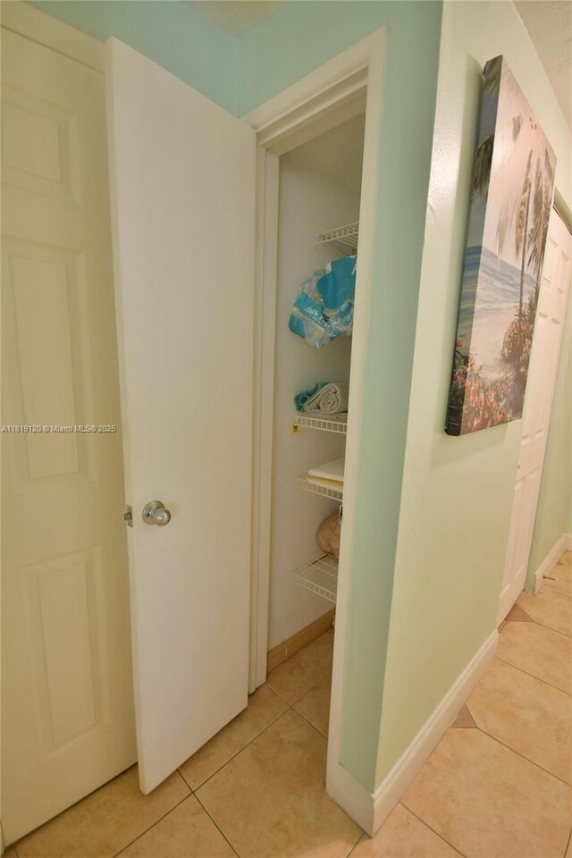 5815 S Farragut Dr, Hollywood, FL 33021 - hallway featuring light tile patterned floors and baseboards