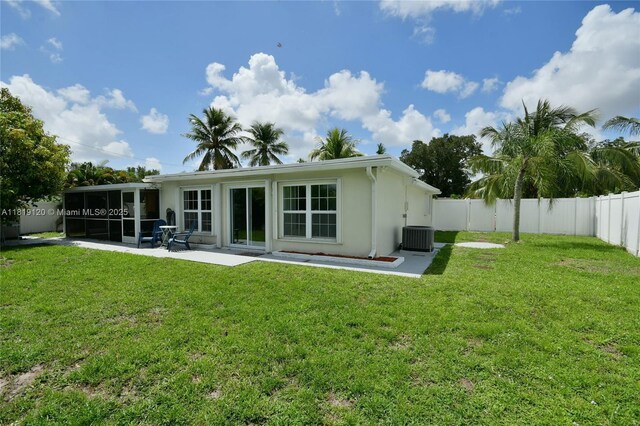 5815 S Farragut Dr, Hollywood, FL 33021 - back of property with a sunroom, a fenced backyard, stucco siding, and a patio area