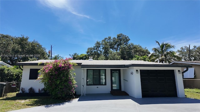 4521 SW 25th Ter, Dania Beach, FL 33312 - view of front of house with driveway, an attached garage, and stucco siding