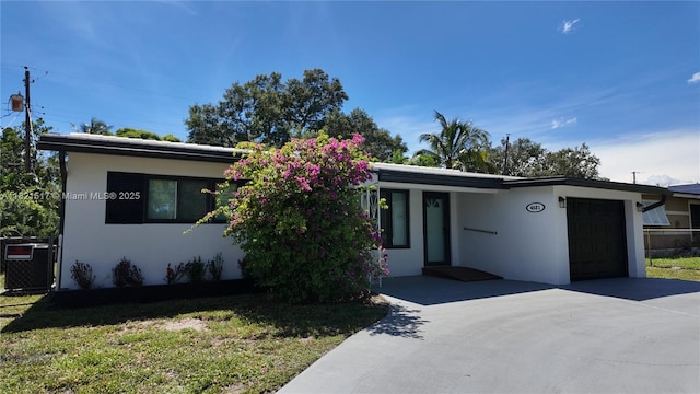 4521 SW 25th Ter, Dania Beach, FL 33312 - view of front facade with stucco siding, a garage, and driveway