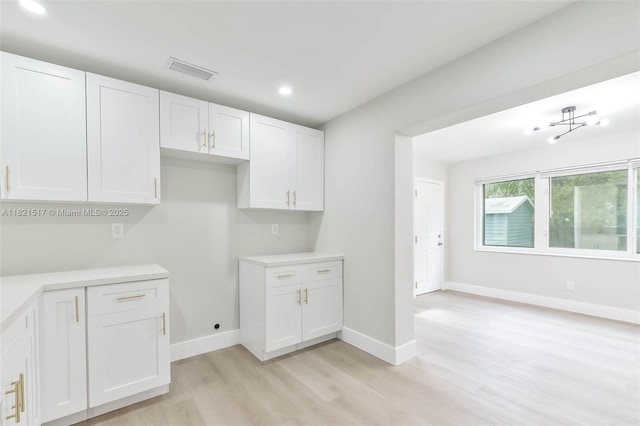 4521 SW 25th Ter, Dania Beach, FL 33312 - kitchen with light wood-type flooring, recessed lighting, white cabinets, and light countertops