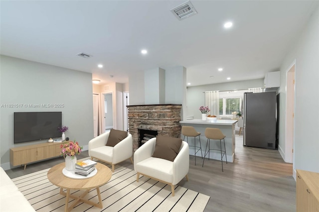 4521 SW 25th Ter, Dania Beach, FL 33312 - living room featuring light wood-style floors, recessed lighting, and a stone fireplace