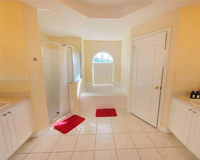 357 Moscato Dr, Davenport, FL 33897 - bathroom with a stall shower, vanity, a bath, and tile patterned flooring