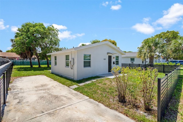 1001 NW 4th Ave, Pompano Beach, FL 33060 - back of house with stucco siding, a fenced backyard, and a patio