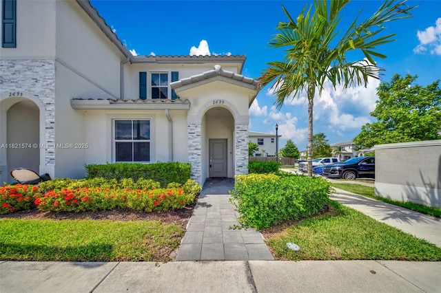 2699 SE 19th St, Homestead, FL 33035 - view of front of property featuring stucco siding, stone siding, and a tiled roof