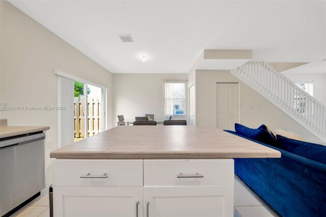 2699 SE 19th St, Homestead, FL 33035 - kitchen featuring dishwasher, open floor plan, a kitchen island, light tile patterned floors, and white cabinets