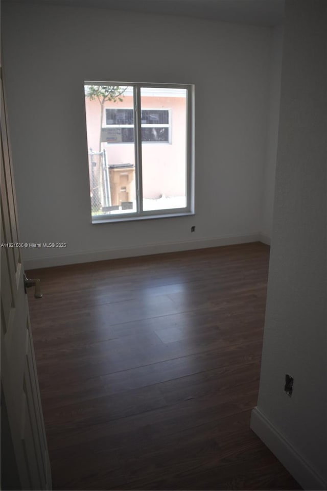 363 SW 1st Ter, Deerfield Beach, FL 33441 - unfurnished room with dark wood-type flooring and baseboards
