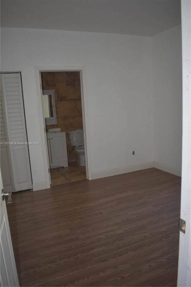 363 SW 1st Ter, Deerfield Beach, FL 33441 - empty room featuring dark wood finished floors and baseboards