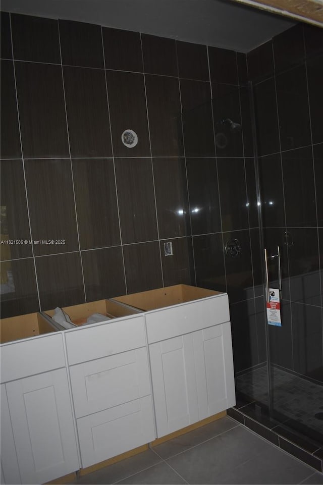 363 SW 1st Ter, Deerfield Beach, FL 33441 - full bath with a stall shower, tile patterned floors, and tile walls