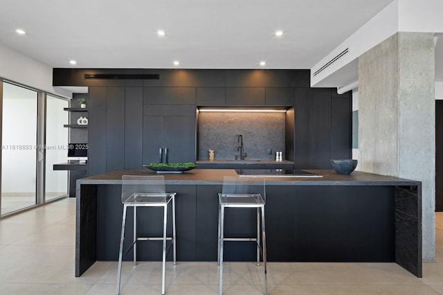 11 Island Ave Unit Ph2, Miami Beach, FL 33139 - kitchen featuring dark countertops, modern cabinets, open shelves, a kitchen bar, and recessed lighting
