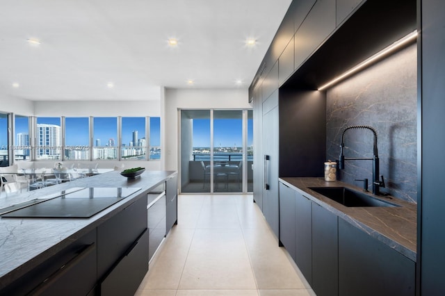 11 Island Ave Unit Ph2, Miami Beach, FL 33139 - kitchen featuring modern cabinets, a view of skyline, black electric cooktop, recessed lighting, and light tile patterned floors
