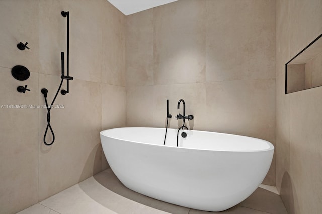11 Island Ave Unit Ph2, Miami Beach, FL 33139 - full bath with tile walls, a soaking tub, and tile patterned flooring