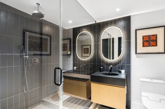 11 Island Ave Unit Ph2, Miami Beach, FL 33139 - bathroom with vanity, a stall shower, tile walls, tasteful backsplash, and recessed lighting