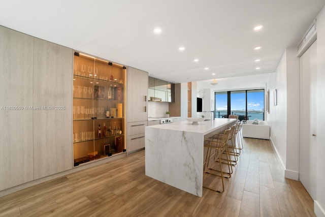 650 NE 32nd St Unit 1904, Miami, FL 33137 - kitchen featuring modern cabinets, light wood-type flooring, a large island, recessed lighting, and a kitchen breakfast bar