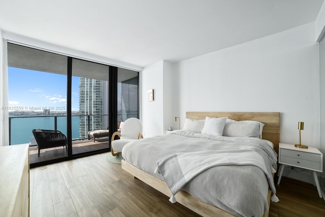 650 NE 32nd St Unit 1904, Miami, FL 33137 - bedroom with wood finished floors, expansive windows, and access to outside