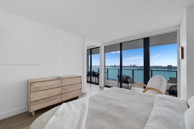 650 NE 32nd St Unit 1904, Miami, FL 33137 - bedroom featuring access to exterior, floor to ceiling windows, wood finished floors, and a water view