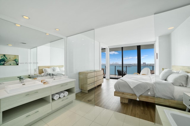 650 NE 32nd St Unit 1904, Miami, FL 33137 - bedroom with a water view, access to exterior, recessed lighting, and a wall of windows