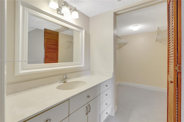 8860 SW 123rd Ct Unit K-104, Miami, FL 33186 - bathroom featuring a textured ceiling and vanity