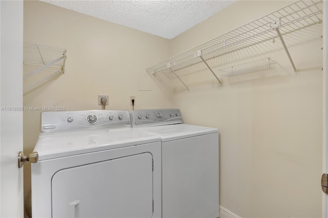 8860 SW 123rd Ct Unit K-104, Miami, FL 33186 - laundry room featuring washing machine and dryer and a textured ceiling