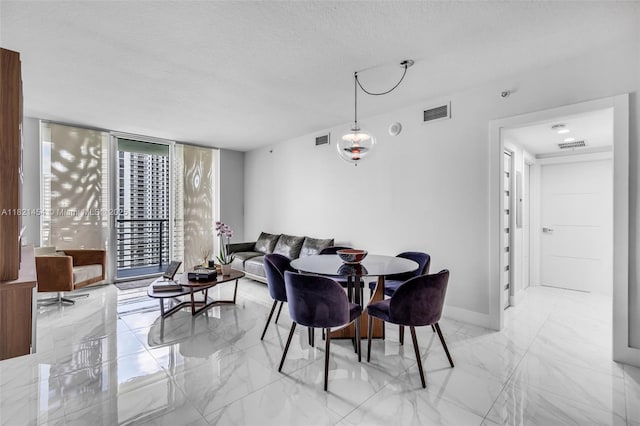 325 S Biscayne Blvd Unit 2515, Miami, FL 33131 - dining area featuring light marble finish flooring, expansive windows, and a textured ceiling