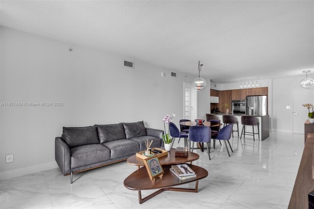 325 S Biscayne Blvd Unit 2515, Miami, FL 33131 - living room featuring light marble finish floors and baseboards