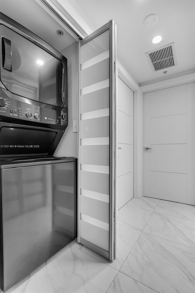 325 S Biscayne Blvd Unit 2515, Miami, FL 33131 - laundry room with stacked washer / dryer and light marble finish floors