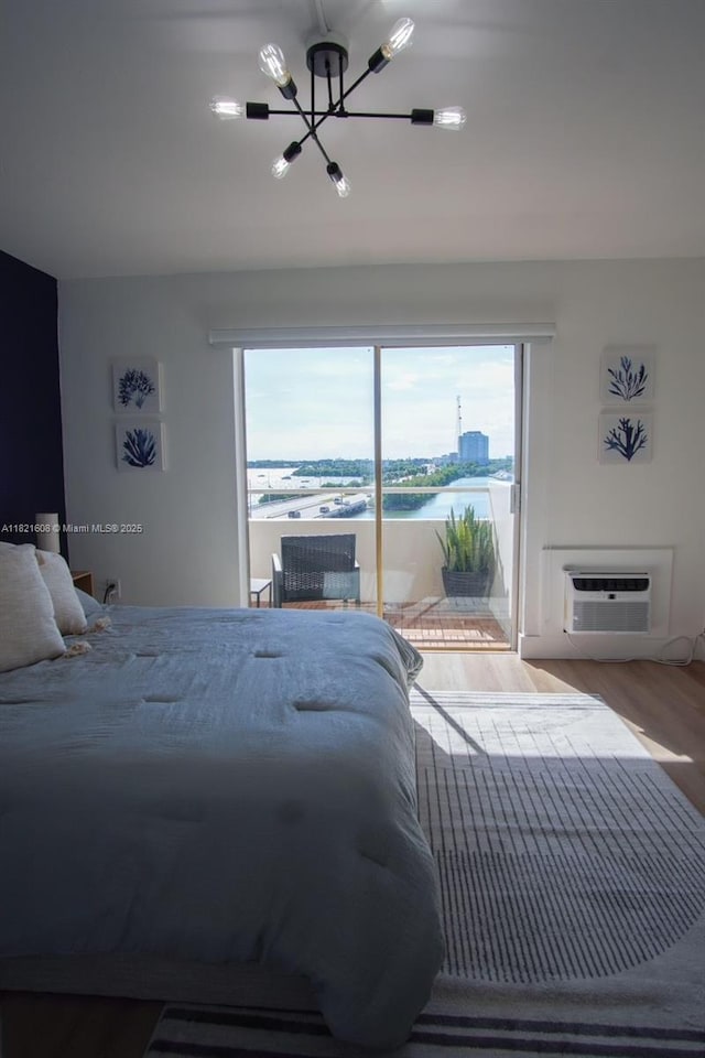 7904 W Dr Unit 501, North Bay Village, FL 33141 - bedroom with a chandelier, a wall mounted AC, access to outside, and multiple windows