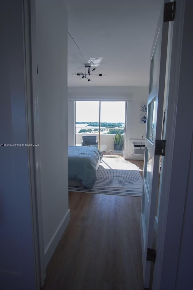 7904 W Dr Unit 501, North Bay Village, FL 33141 - bedroom featuring wood finished floors and a wall mounted air conditioner