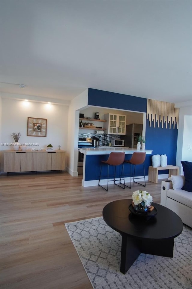 7904 W Dr Unit 501, North Bay Village, FL 33141 - living area featuring light wood-style floors and baseboards