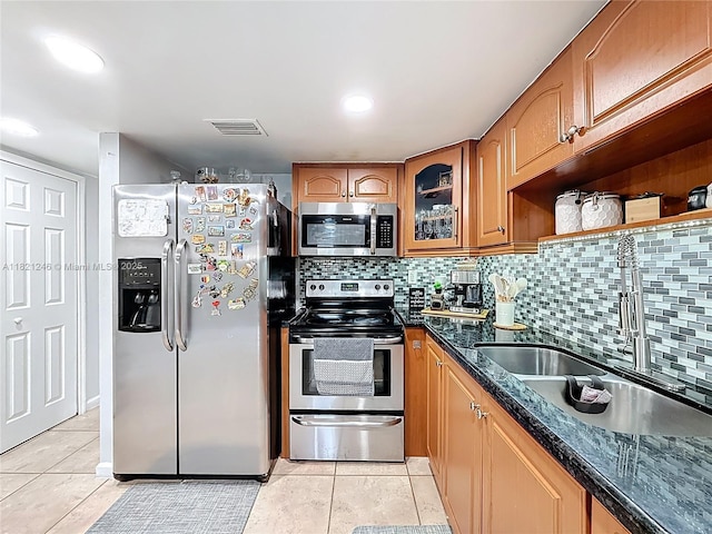 1782 W 42nd St Unit 1782, Hialeah, FL 33012 - kitchen with stainless steel appliances, light tile patterned floors, decorative backsplash, and glass insert cabinets