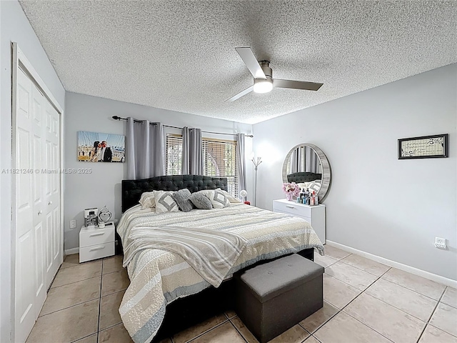 1782 W 42nd St Unit 1782, Hialeah, FL 33012 - bedroom with light tile patterned flooring, a ceiling fan, a closet, and a textured ceiling