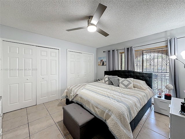 1782 W 42nd St Unit 1782, Hialeah, FL 33012 - bedroom with light tile patterned floors, two closets, a ceiling fan, and a textured ceiling
