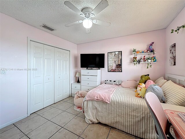 1782 W 42nd St Unit 1782, Hialeah, FL 33012 - bedroom featuring light tile patterned floors, a textured ceiling, a closet, and a ceiling fan