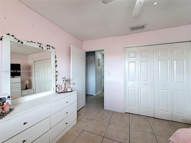 1782 W 42nd St Unit 1782, Hialeah, FL 33012 - bedroom featuring light tile patterned flooring, a textured ceiling, a closet, and a ceiling fan
