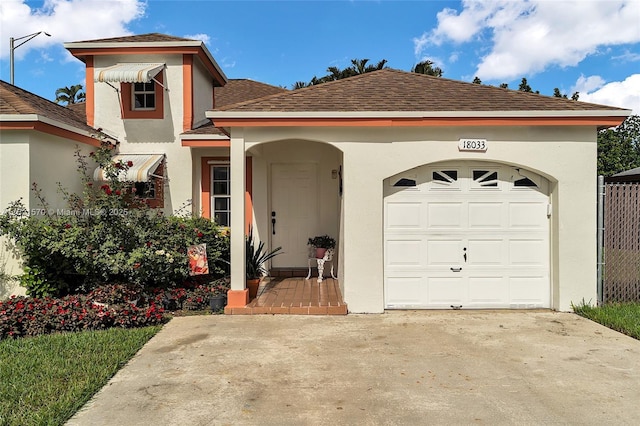 18033 SW 137th Ct, Miami, FL 33177 - view of front of property with stucco siding, an attached garage, roof with shingles, and driveway