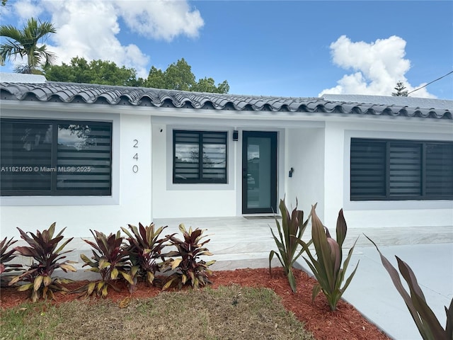 240 SW 55th Ave, Miami, FL 33134 - view of front of home with covered porch, stucco siding, and a tile roof