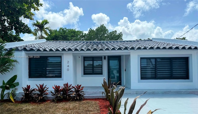240 SW 55th Ave, Miami, FL 33134 - view of front of home with a tiled roof, stucco siding, and a porch