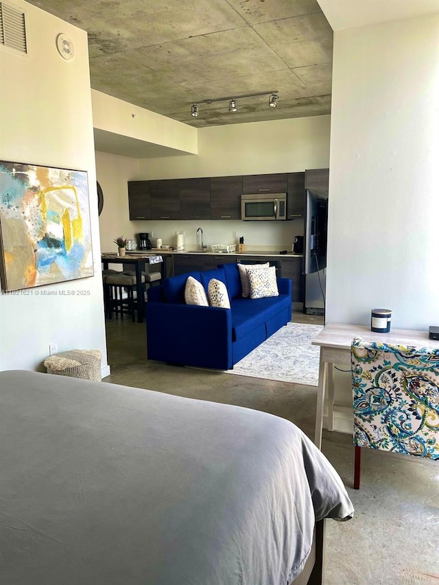 151 SE 1st St Unit 2406, Miami, FL 33131 - bedroom with freestanding refrigerator and concrete floors