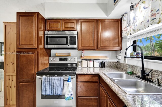 2041 Arcadia Dr, Miramar, FL 33023 - kitchen featuring stainless steel appliances and brown cabinetry