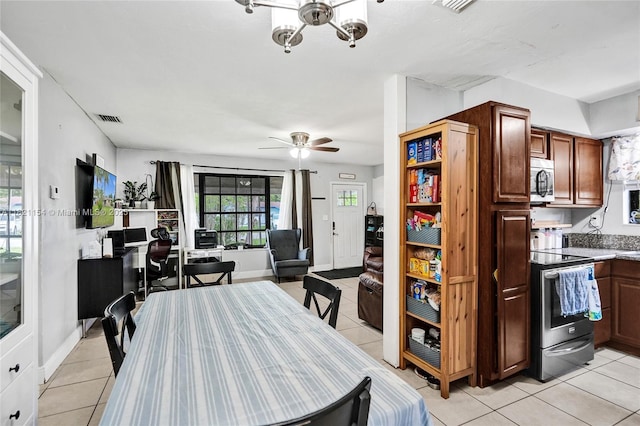 2041 Arcadia Dr, Miramar, FL 33023 - dining area featuring light tile patterned floors, ceiling fan, and a chandelier