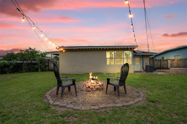 2041 Arcadia Dr, Miramar, FL 33023 - rear view of property featuring an outdoor fire pit, a fenced backyard, and stucco siding